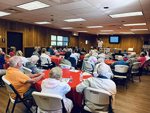 A room full of mature drivers watching a instructor teach a PA driver safety course